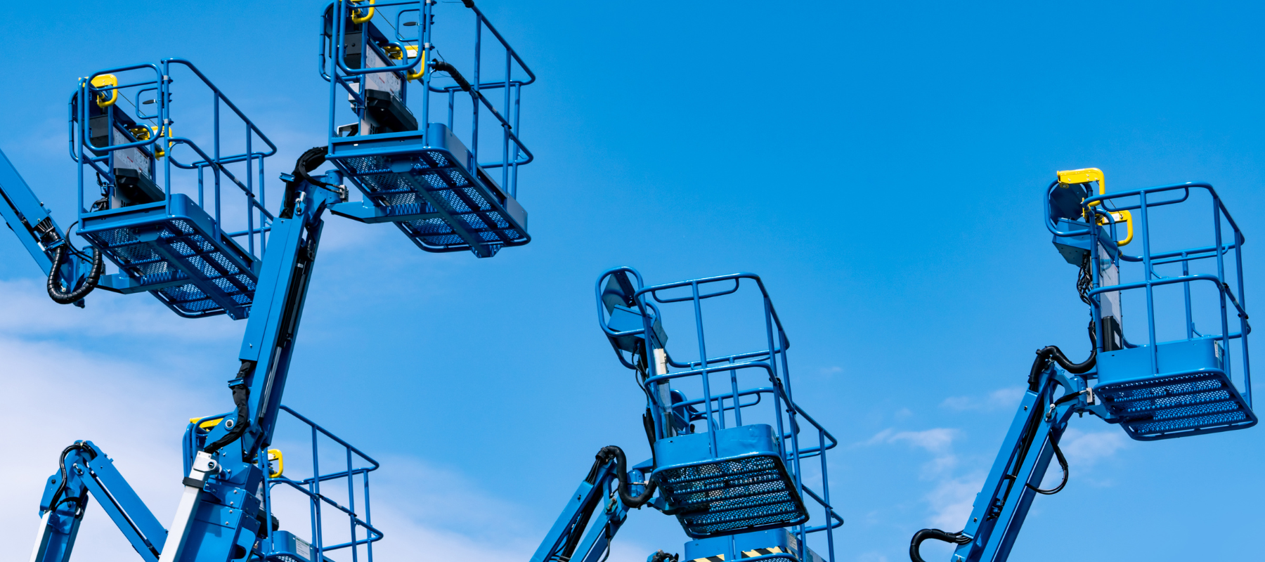 Boom lift fleet on a clear day